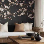 Modern living room with a dark floral accent wall, neutral-toned sofa with textured pillows, and a rustic wooden coffee table with decorative ceramics.